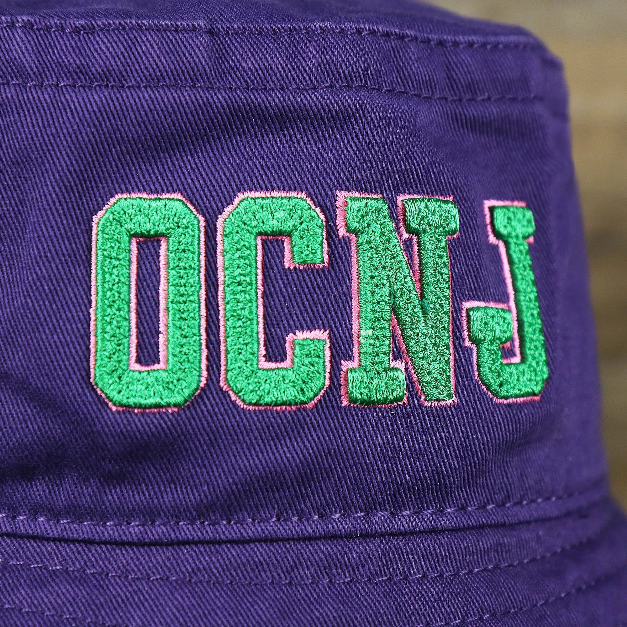 Green OCNJ Double Wordmark Pink Outline Bucket Hat | Purple Bucket Hat