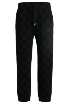 Loose-fit tracksuit bottoms with checkerboard print